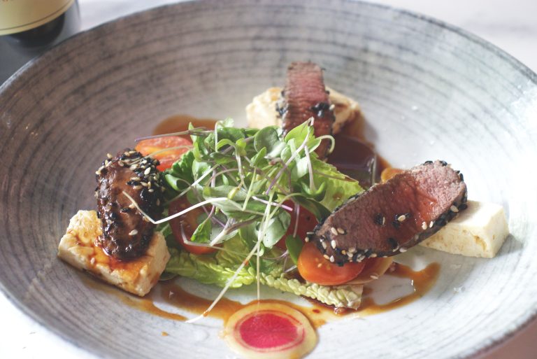 Saltbush Lamb Fillet Sesame crusted with halloumi, pomegranate, and watermelon radish. Paired with St Hallett Black Clay Cabernet Sauvignon.