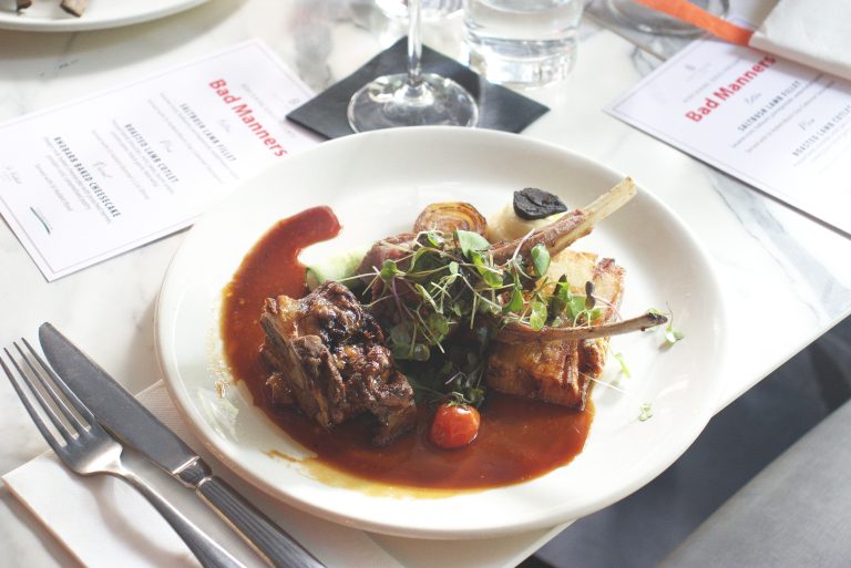 Roasted Lamb Cutlet Accompanied by pressed lamb shoulder, mint, peas, burnt onion, potato pavé, and black garlic feta whip. Paired with St Hallett Butcher’s Cart Shiraz.