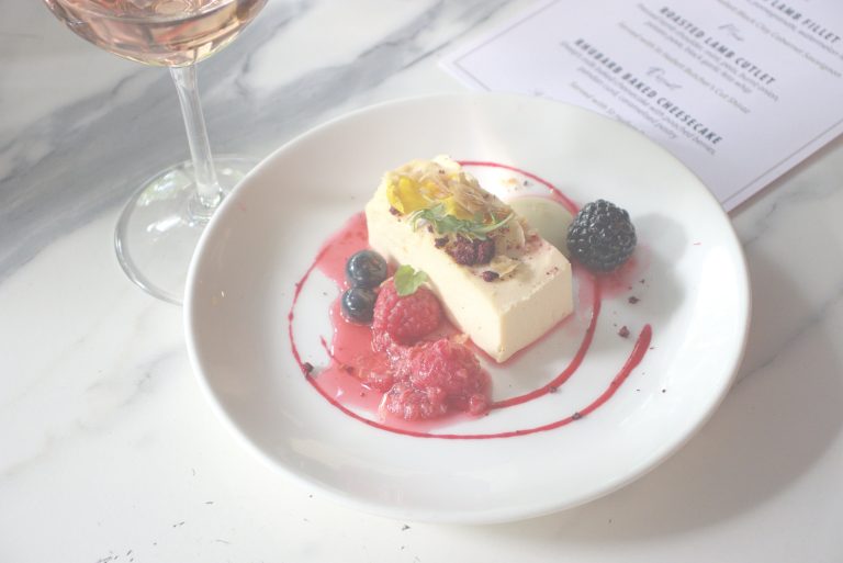Rhubarb Baked Cheesecake A sheep’s milk baked cheesecake with poached berries, pandan curd, and caramelized pastry. Paired with St Hallett Rosé.